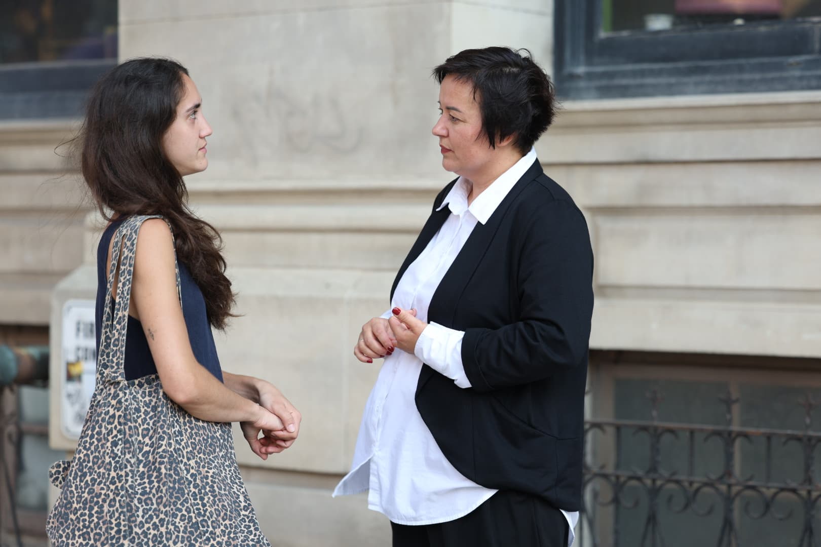 Ruslana speaking with a woman during an outdoor consultation